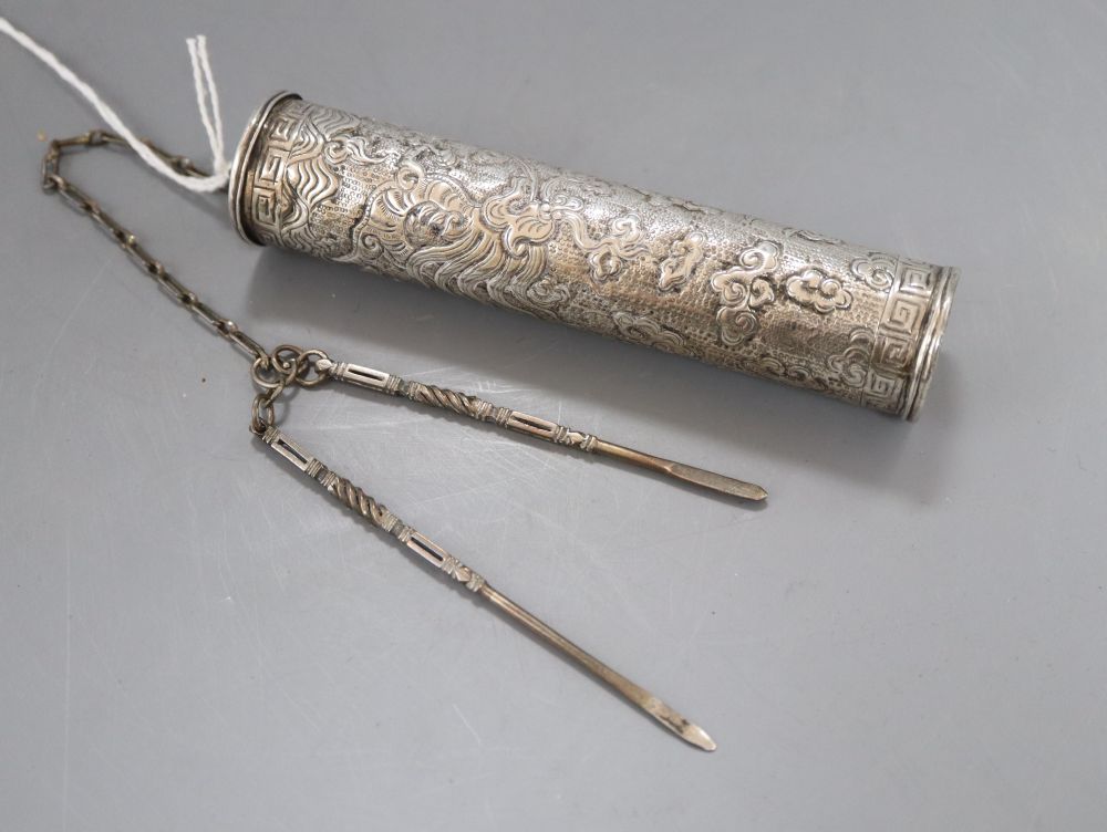An early 20th century Middle Eastern repousse white metal incense case, 11.2cm, with two implements on a chain, gross 53 grams.